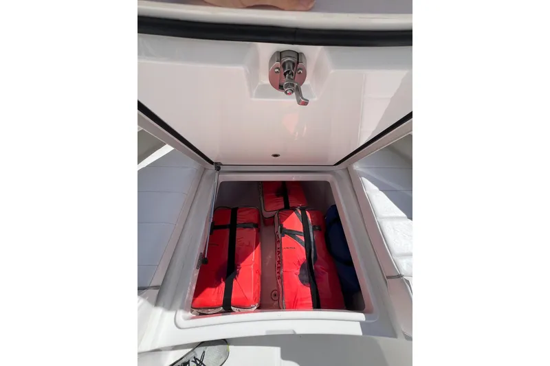 Slide: The Image of Storage compartment on 2016 Regulator 34 Center Console with red life jackets. - 27