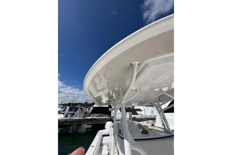 Slide: The Image of 2016 Regulator 34 Center Console boat at marina under clear blue sky. - 3