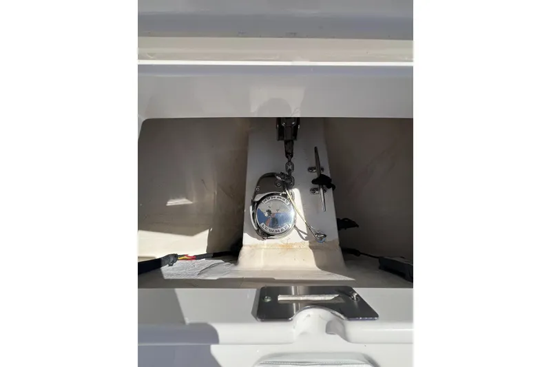 Slide: The Image of 2016 Regulator 34 Center Console storage compartment with equipment and wiring. - 30