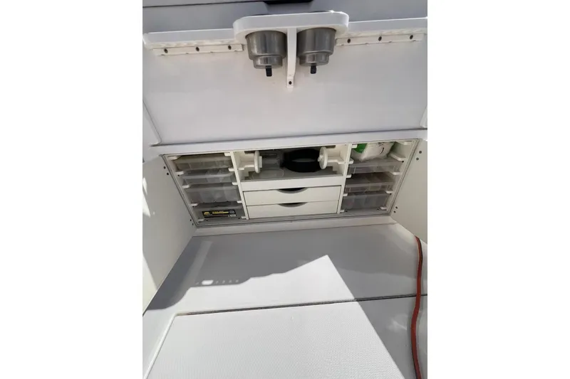 Slide: The Image of 2016 Regulator 34 Center Console storage compartment with organized drawers and containers. - 31