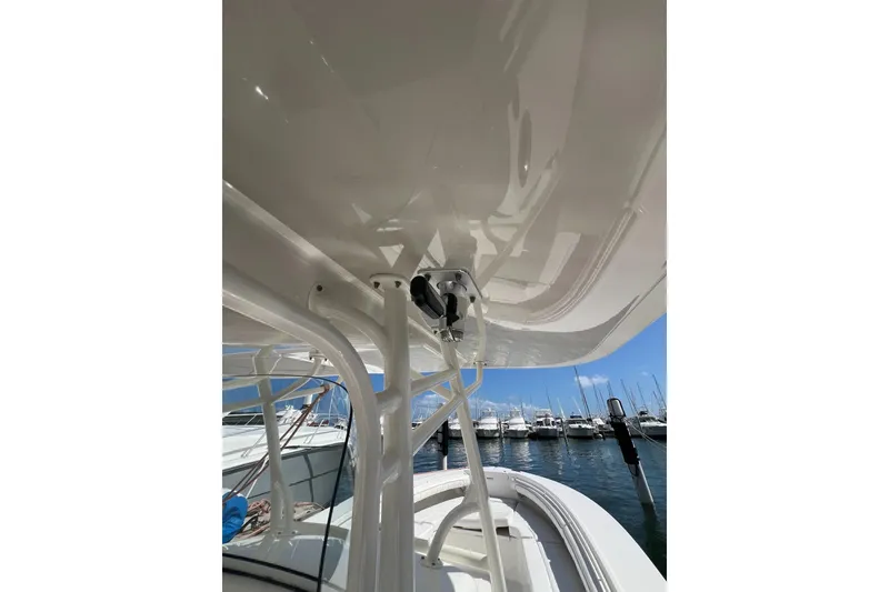 Slide: The Image of 2016 Regulator 34 Center Console boat at marina, showcasing sleek design and structure. - 5