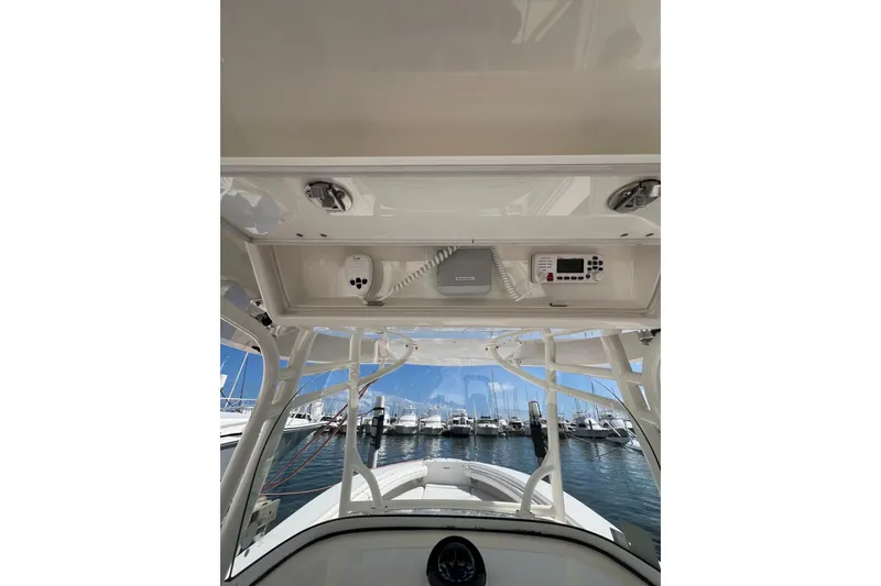 Slide: The Image of 2016 Regulator 34 Center Console boat interior with electronics, docked at marina. - 8