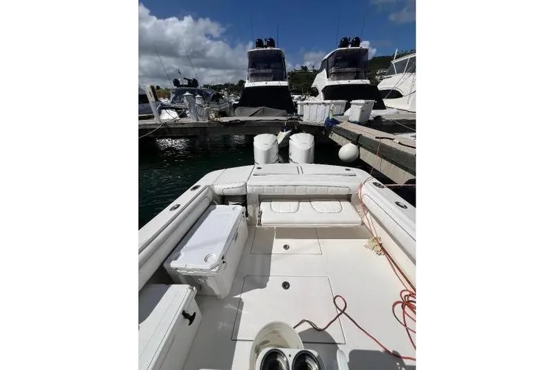 Slide: The Image of 2016 Regulator 34 Center Console boat docked at marina, clear sky background. - 9