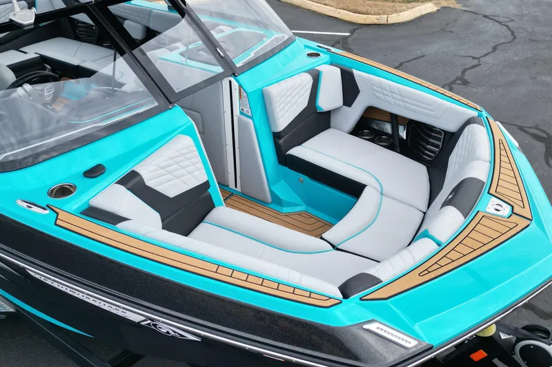 Slide: The Image of 2022 Nautique Super Air Nautique G21 boat interior with turquoise and white seating. - 11
