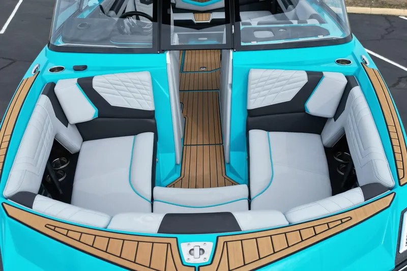 Slide: The Image of 2022 Nautique Super Air Nautique G21 interior with turquoise and white seating. - 12