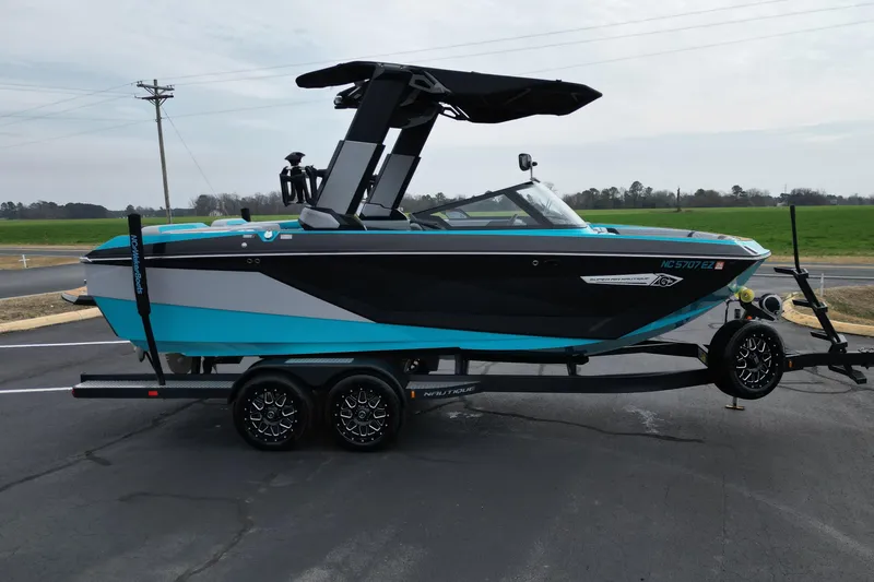 Slide: The Image of 2022 Nautique Super Air Nautique G21 boat on trailer, black and turquoise design. - 3