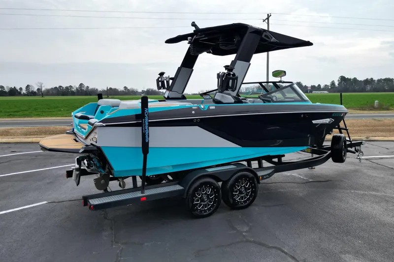 Slide: The Image of 2022 Nautique Super Air Nautique G21 boat on trailer, blue and black design. - 5