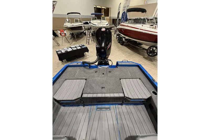 Slide: The Image of 2026 Vexus AVX 1985s boat interior with motor, displayed at a showroom. - 11