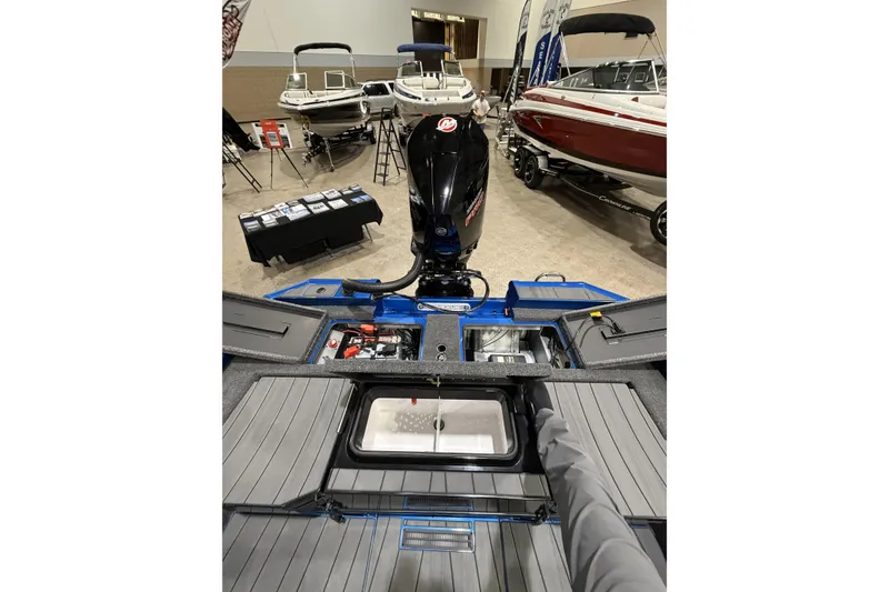 Slide: The Image of 2026 Vexus AVX 1985s boat interior at a showroom, showcasing engine and storage compartments. - 12