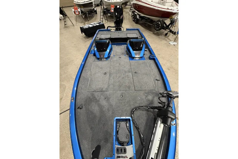 Slide: The Image of 2026 Vexus AVX 1985s boat interior with blue trim and carpeted deck. - 4