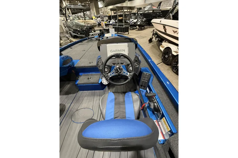Slide: The Image of 2026 Vexus AVX 1985s boat interior with Garmin navigation system, blue seating, and steering wheel. - 7