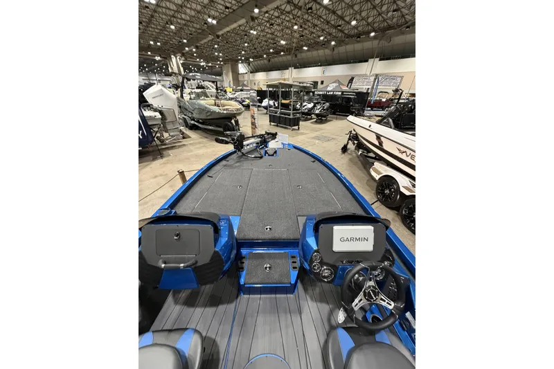 Slide: The Image of 2026 Vexus AVX 1985s boat interior with Garmin navigation, displayed at a boat show. - 8