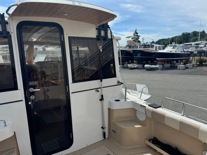 Slide: The Image of 2015 Cutwater C-26 boat docked, showcasing rear deck and cabin entrance. - 10