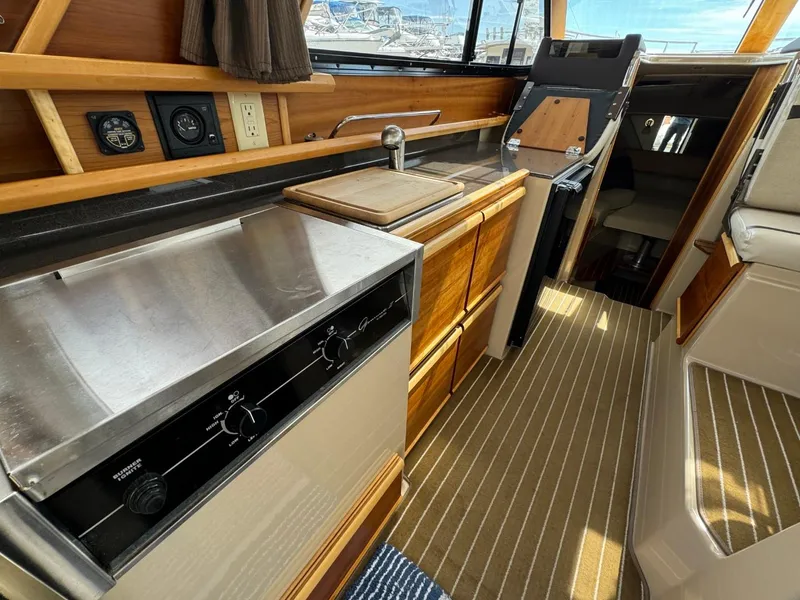 Slide: The Image of Interior of 2015 Cutwater C-26 boat with kitchen and navigation area. - 13