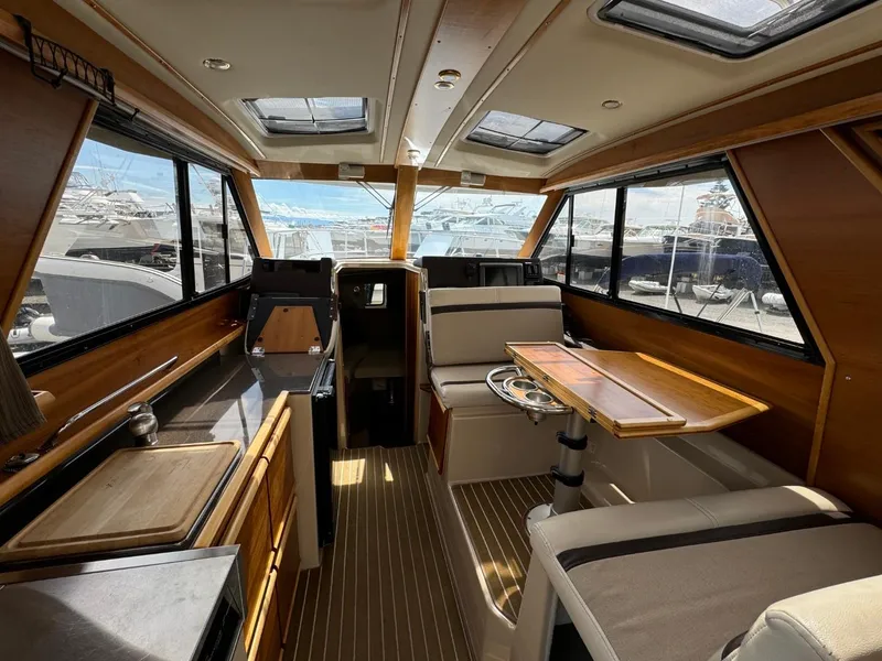 Slide: The Image of Interior of 2015 Cutwater C-26 boat with wood accents and seating area. - 17