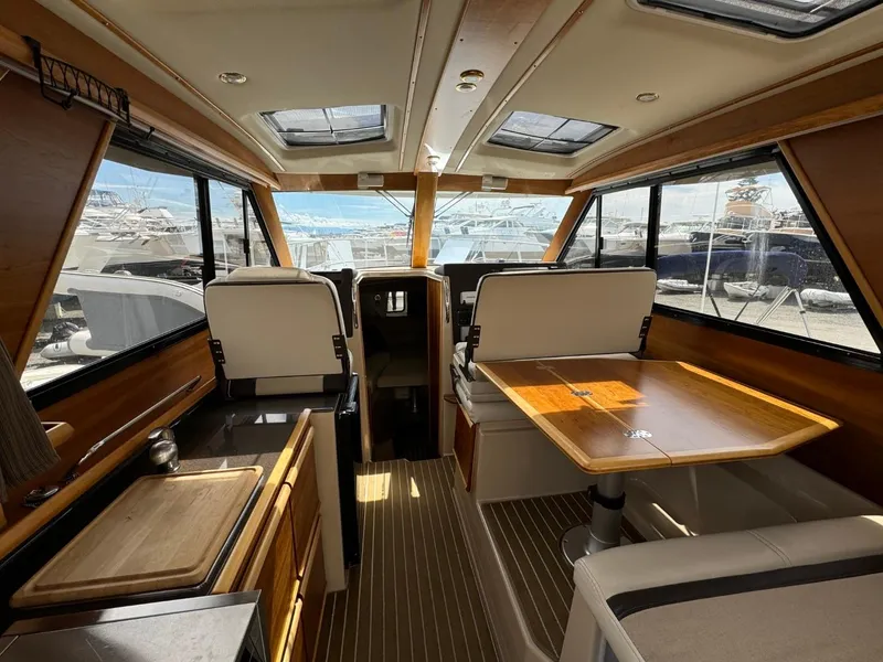 Slide: The Image of Interior of 2015 Cutwater C-26 boat with wood accents and seating area. - 18