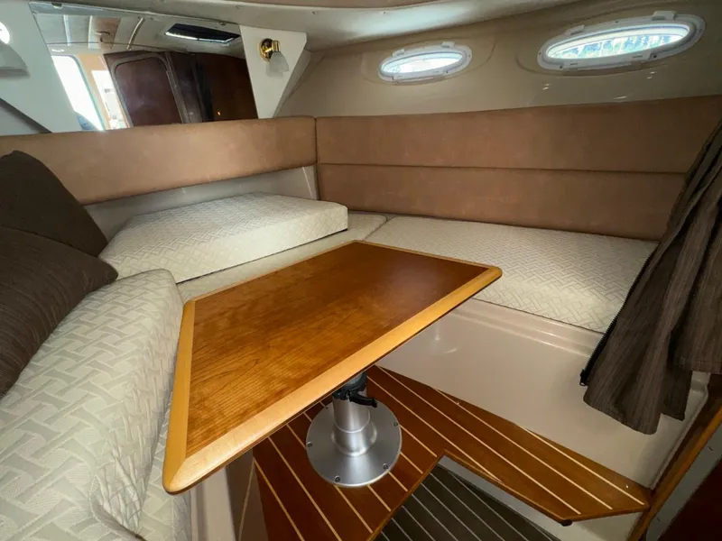Slide: The Image of 2015 Cutwater C-26 cabin interior with cozy seating and wooden table. - 19