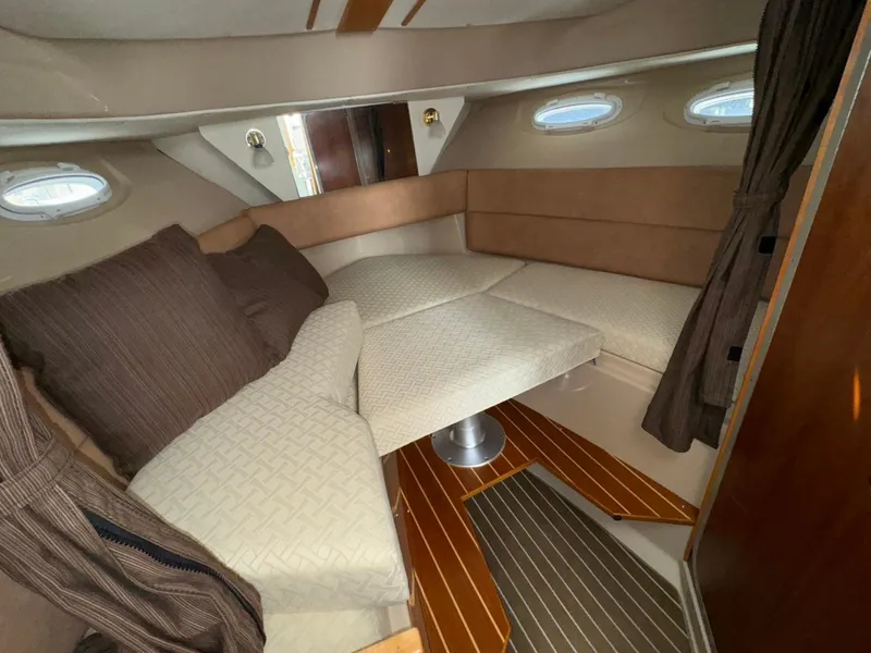 Slide: The Image of 2015 Cutwater C-26 cabin interior with cozy seating and elegant wood flooring. - 21