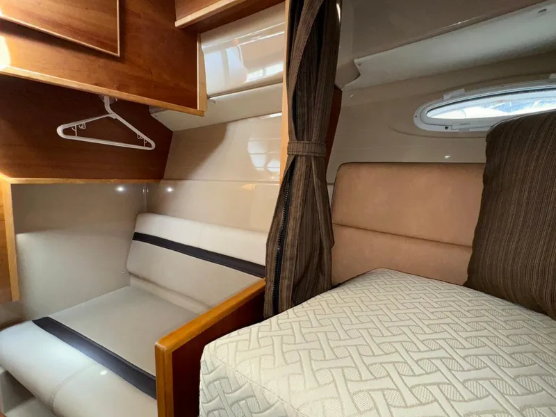 Slide: The Image of 2015 Cutwater C-26 cabin interior with seating, bed, and storage. - 22