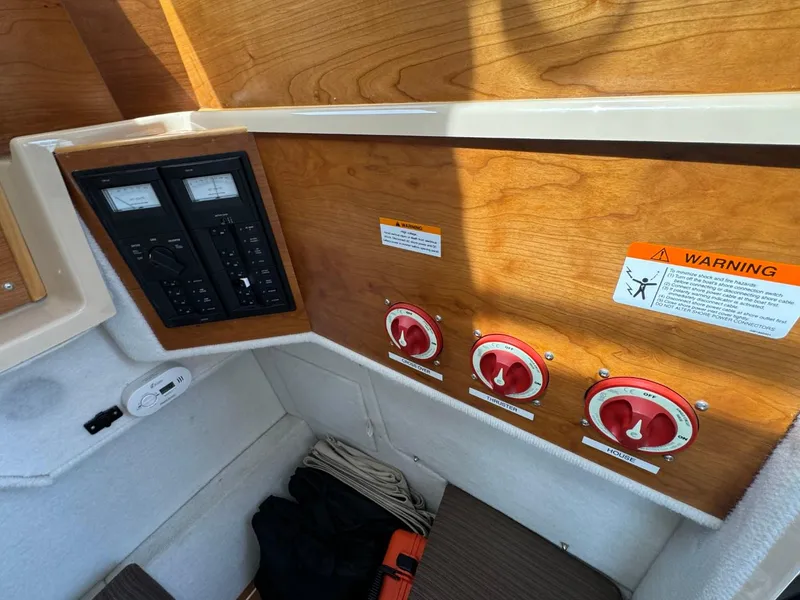 Slide: The Image of Control panel and switches inside a 2015 Cutwater C-26 boat cabin. - 26