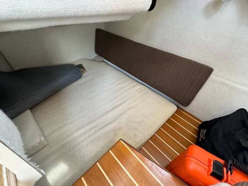 Slide: The Image of 2015 Cutwater C-26 cabin interior with cushioned seating and wooden flooring. - 27