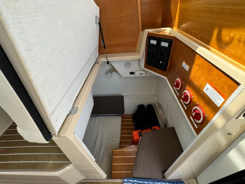 Slide: The Image of 2015 Cutwater C-26 cabin interior with control panel and storage area. - 28