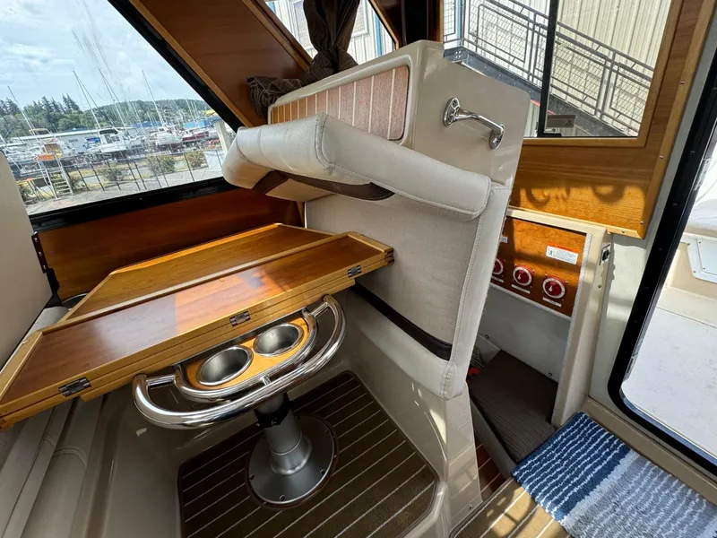 Slide: The Image of Interior of 2015 Cutwater C-26 boat with wooden table and seating. - 29