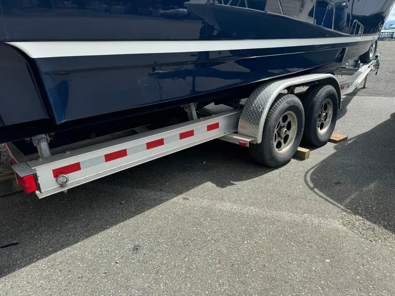 Slide: The Image of 2015 Cutwater C-26 boat on a dual-axle trailer, parked on asphalt. - 3