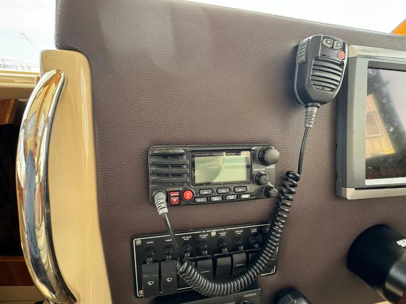 Slide: The Image of Control panel of a 2015 Cutwater C-26 boat with radio and microphone. - 32