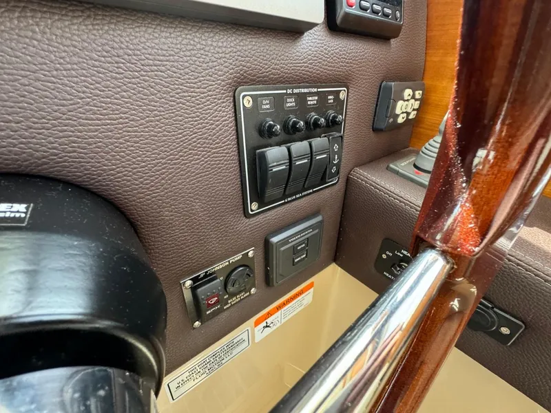 Slide: The Image of Control panel of a 2015 Cutwater C-26 boat with switches and dials. - 34