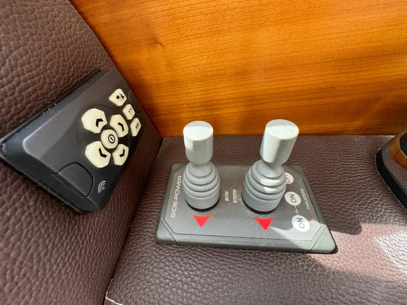 Slide: The Image of Control panel with joysticks and buttons on a 2015 Cutwater C-26 boat. - 35