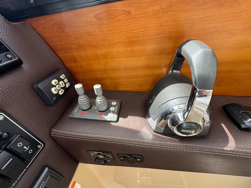 Slide: The Image of Control panel of a 2015 Cutwater C-26 boat with joystick and throttle. - 38