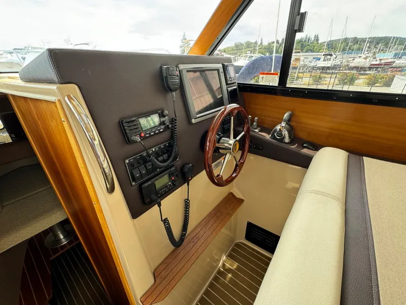 Slide: The Image of 2015 Cutwater C-26 helm with navigation controls and wooden steering wheel. - 39