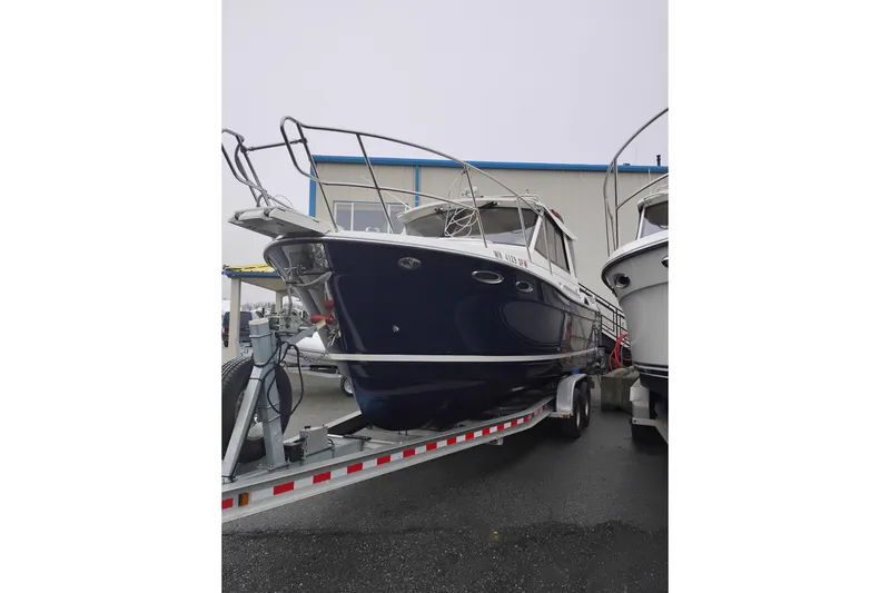 Slide: The Image of 2015 Cutwater C-26 boat on trailer, parked outdoors near a building. - 4