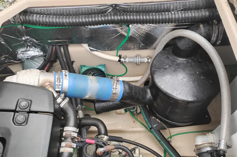 Slide: The Image of Engine compartment of a 2015 Cutwater C-26 boat, showcasing hoses and components. - 43