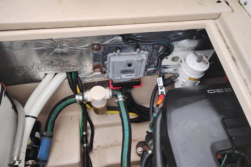 Slide: The Image of Engine compartment of a 2015 Cutwater C-26 boat, showing hoses and components. - 44