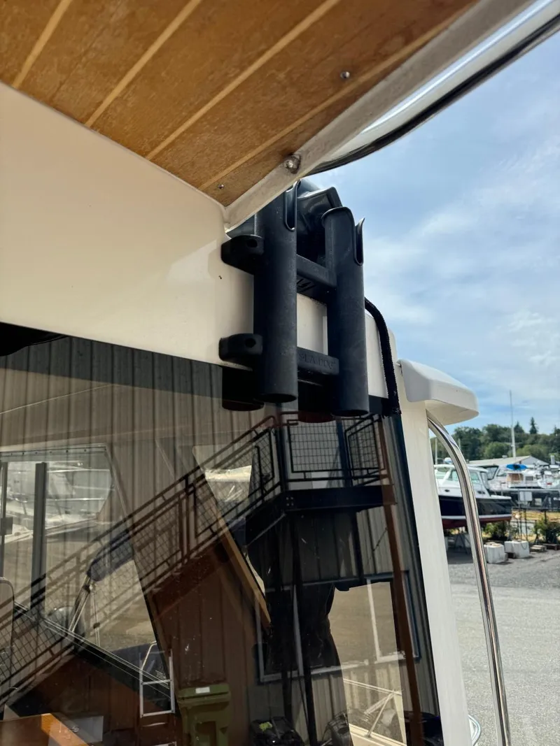 Slide: The Image of 2015 Cutwater C-26 boat with rod holders, docked under a clear sky. - 7