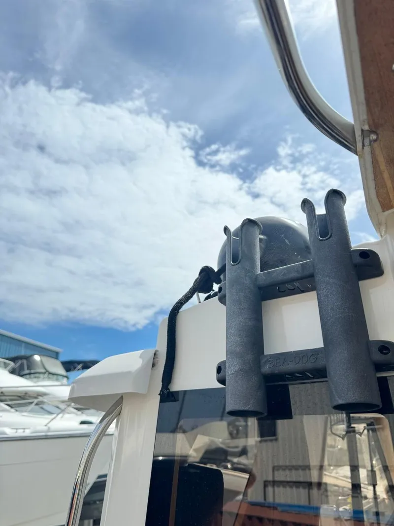 Slide: The Image of 2015 Cutwater C-26 boat detail with rod holders against a cloudy sky. - 8