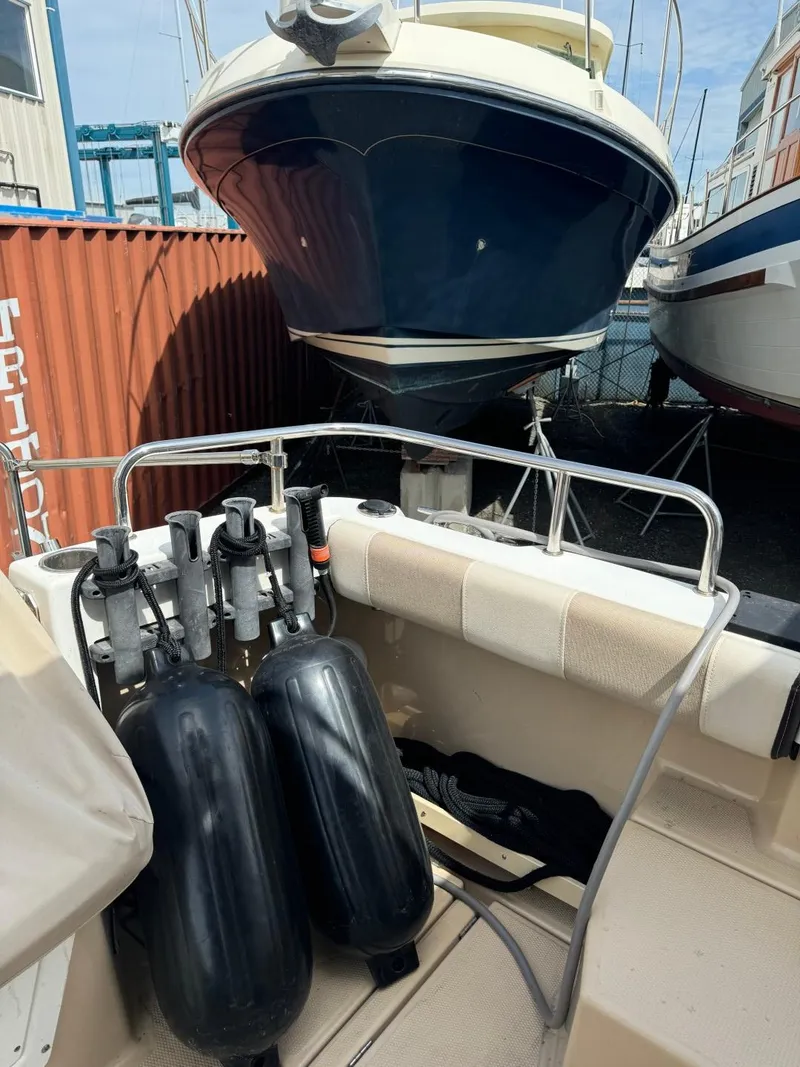 Slide: The Image of 2015 Cutwater C-26 boat with scuba tanks, docked in a marina. - 9