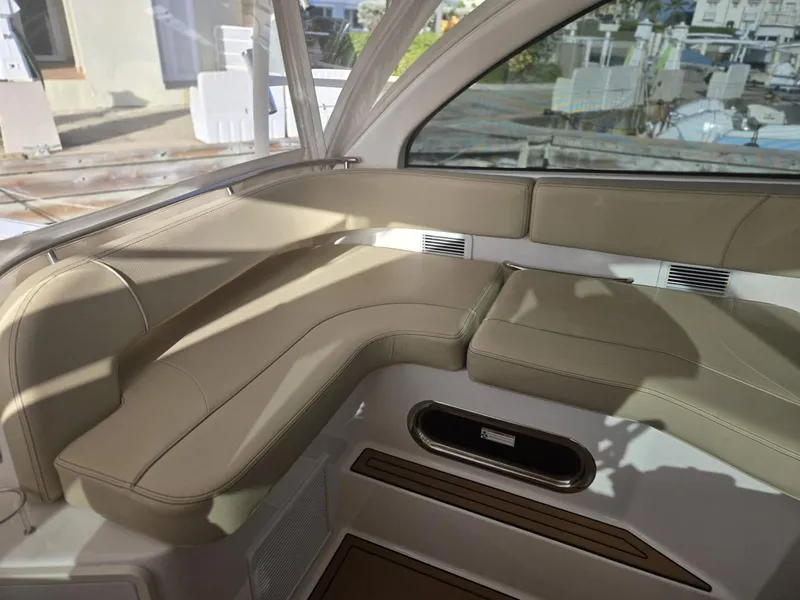 Slide: The Image of 2019 Pursuit OS 385 Offshore boat interior with beige seating and modern design. - 18