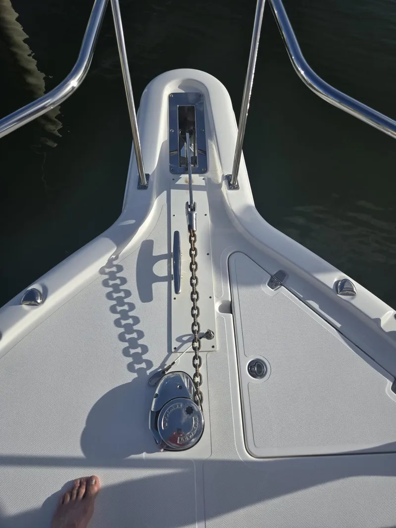 Slide: The Image of 2019 Pursuit OS 385 Offshore boat deck with anchor chain and railing. - 4