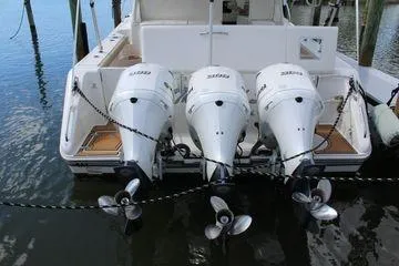 Slide: The Image of 2019 Pursuit OS 385 Offshore boat with triple outboard engines docked. - 7