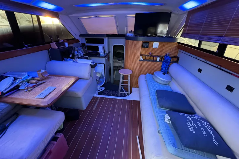 Slide: The Image of Interior of 1990 Luhrs 320 Tournament boat with seating, table, and ambient lighting. - 3
