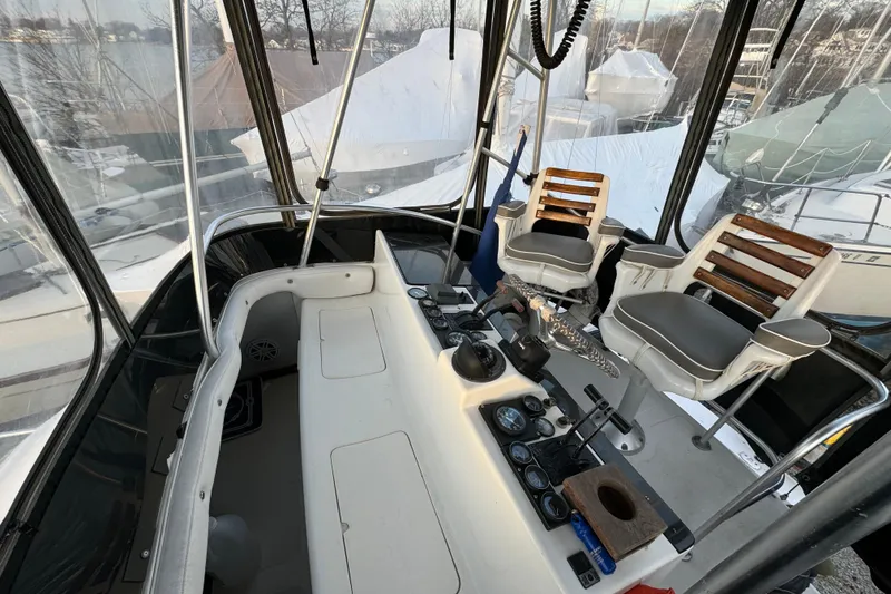 Slide: The Image of 1990 Luhrs 320 Tournament boat cockpit with helm, controls, and seating. - 8