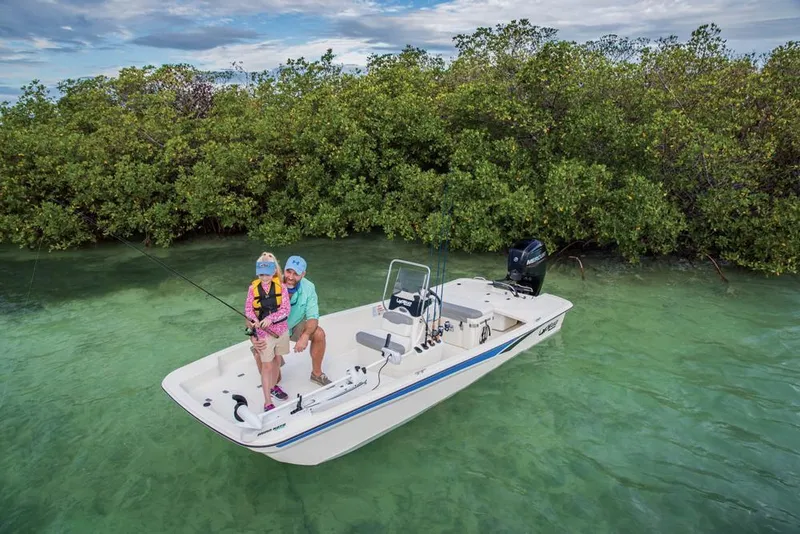 Slide: The Image of Two people fishing on a 2022 Mako Pro Skiff 17 CC boat. - 11