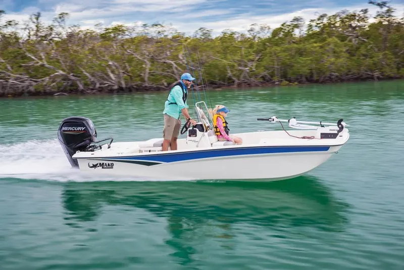 Slide: The Image of 2022 Mako Pro Skiff 17 CC on calm water with two people. - 12