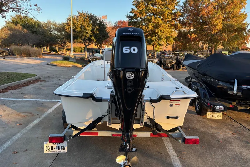 Slide: The Image of 2022 Mako Pro Skiff 17 CC boat with Mercury 60 engine in parking lot. - 6