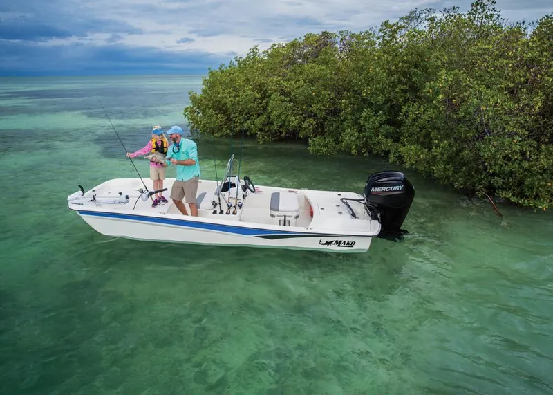 Slide: The Image of 2022 Mako Pro Skiff 17 CC fishing in clear waters. - 8