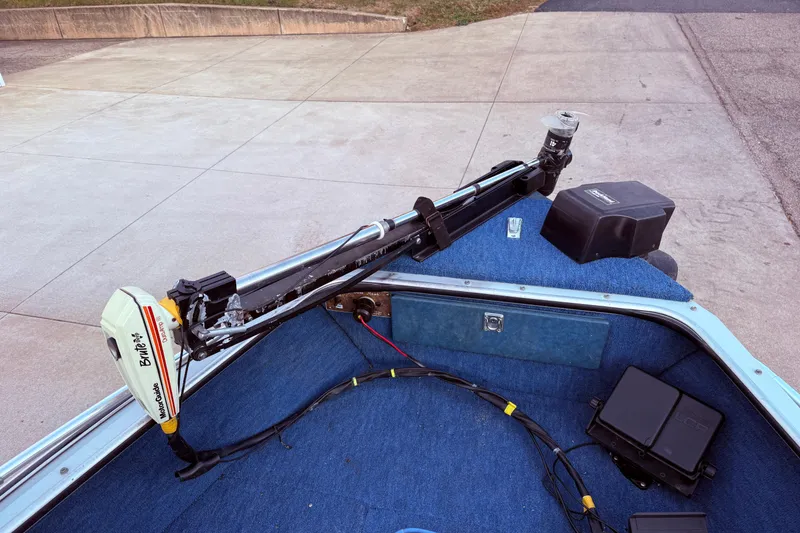 Slide: The Image of 1988 Lund boat with trolling motor and blue carpeted deck. - 10