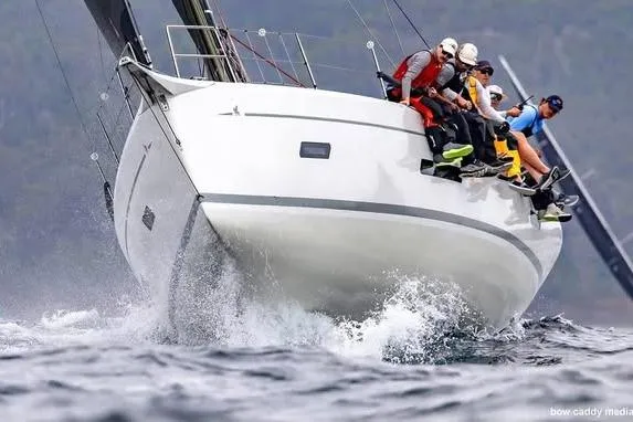 Slide: The Image of Italia Yachts 12.98 (2026) sailing with crew, cutting through waves. - 3